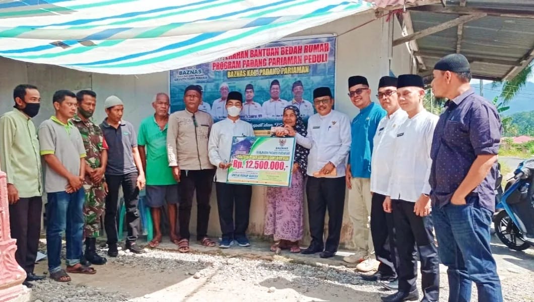 Ketua BAZNAS Kabupaten Padang Pariaman Dr.Tuanku Sulaiman terlihat sedang menyerahkan bantuan RTLH Senilai Rp.12.500.000,- (Poskota.net/Dok Ist)