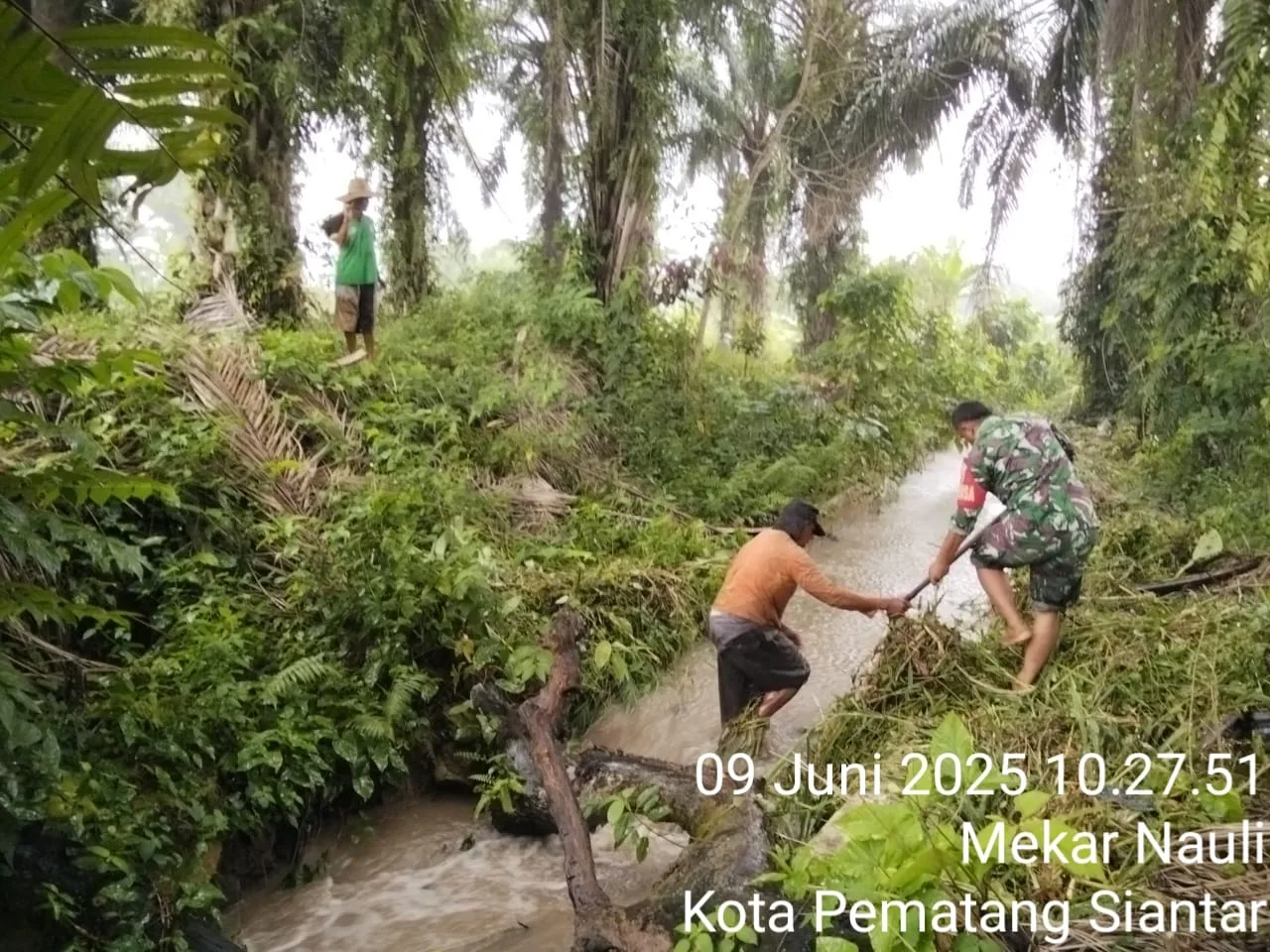 Babinsa Koramil 03/Siantar Selatan Bantu Warga Bersihkan Saluran Irigasi di Kelurahan Mekar Nauli